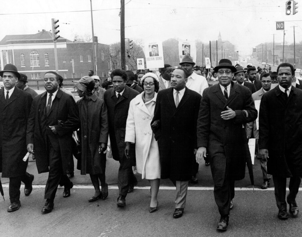 Atlanta, GA - John Lewis, (far right), Dr. Martin Luther King Jr. (third from right), his wife Coretta Scott King, Ralph David Abernathy (second left), lead march from Atlanta University to the Georgia state Capitol.